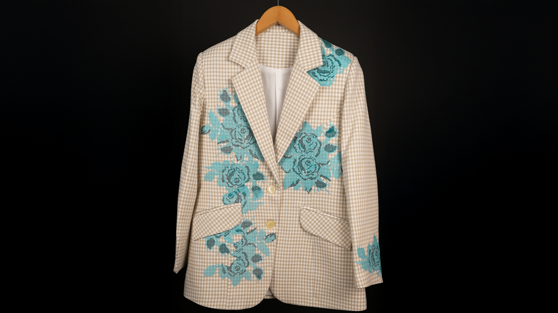 Beige blazer with blue cross-stitched floral embroidery on gingham fabric